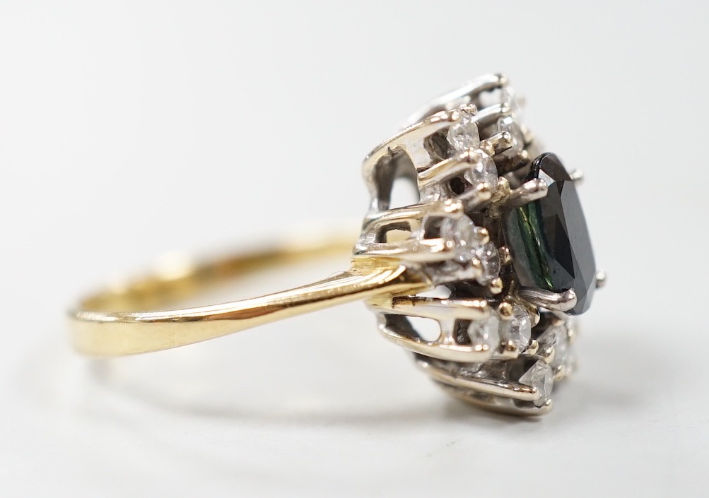 A modern 18ct gold, sapphire and diamond set oval cluster ring, size L, gross weight 4.8 grams.